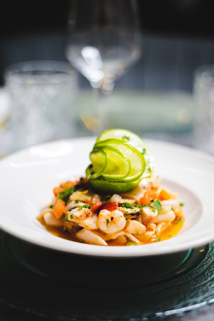 Exquisite seafood platter garnished with lime in a fine dining setup.
